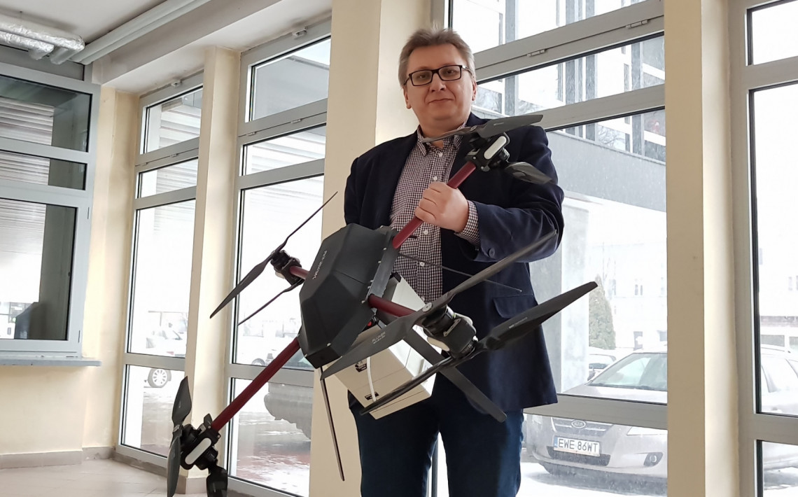 Dr inż. Robert Cichowicz wraz z aparaturę pomiarowo-próbkującą przenoszoną przez zdalnie sterowanego drona
